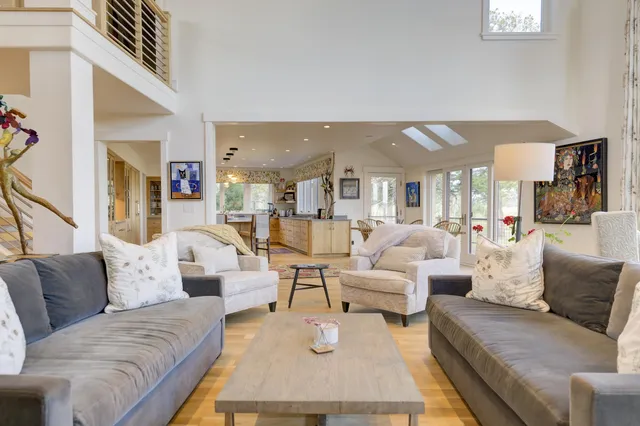 a living room with fireplace furniture and a large window