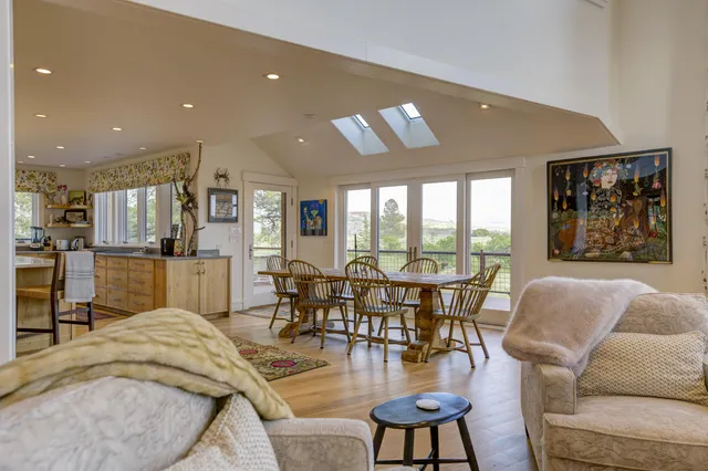 a view of a dining room with furniture wooden floor and chandelier