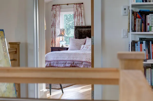 a spacious bedroom with a large bed and a window