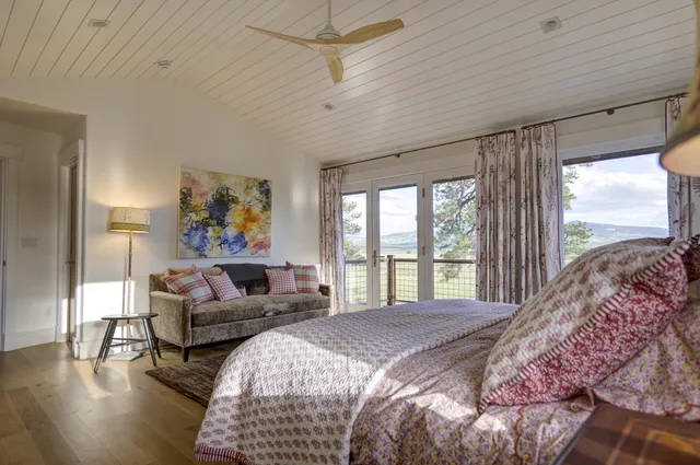 a bedroom with a bed and a mirror