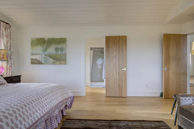 a spacious bathroom with a granite countertop sink a toilet and a shower