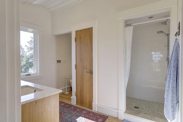 a bathroom with a sink toilet and shower