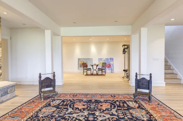 a bedroom with a bed and a refrigerator