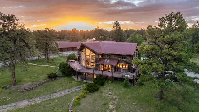 an aerial view of a house with a big yard