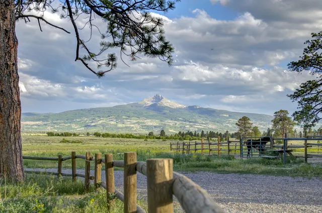 a view of balcony with two chairs and a rug