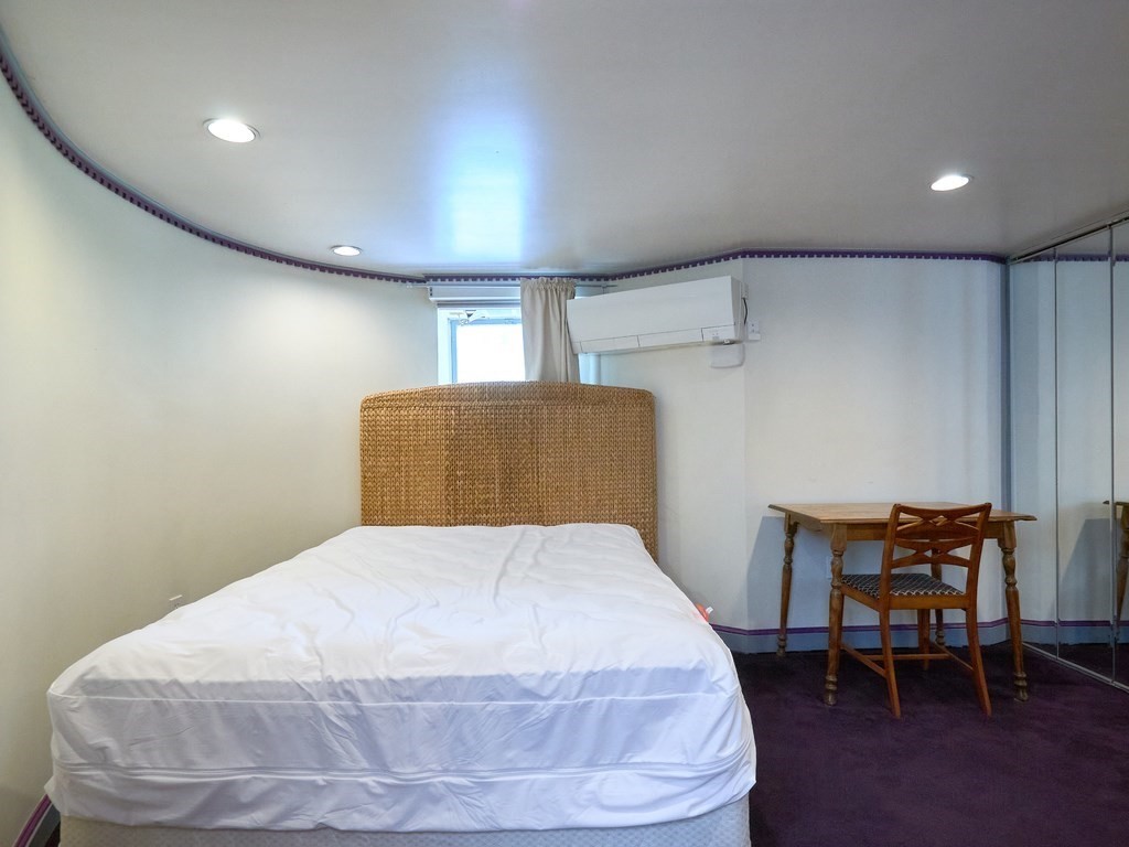 18 Atherton Road, Unit G Brookline, MA 02446 - Photo 11 of 15 a bedroom with a bed and chair