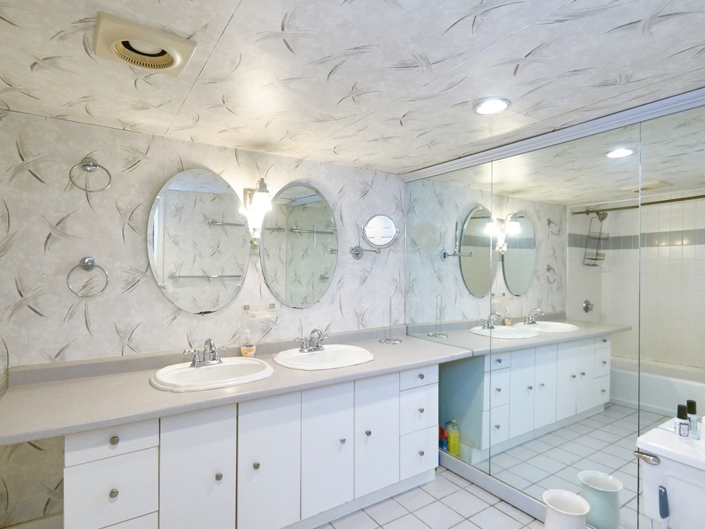 18 Atherton Road, Unit G Brookline, MA 02446 - Photo 13 of 15 a bathroom with a double vanity sink mirror and