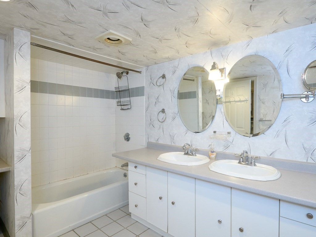 18 Atherton Road, Unit G Brookline, MA 02446 - Photo 14 of 15 a bathroom with a double vanity sink mirror and bathtub