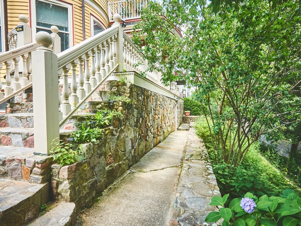 18 Atherton Road, Unit G Brookline, MA 02446 - Photo 3 of 15 a view of a pathway of a house with wooden floor