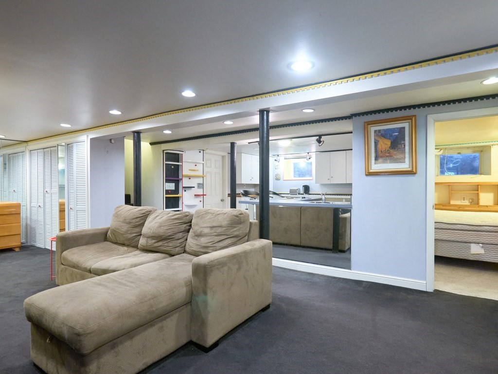 18 Atherton Road, Unit G Brookline, MA 02446 - Photo 5 of 15 a living room with furniture and a kitchen