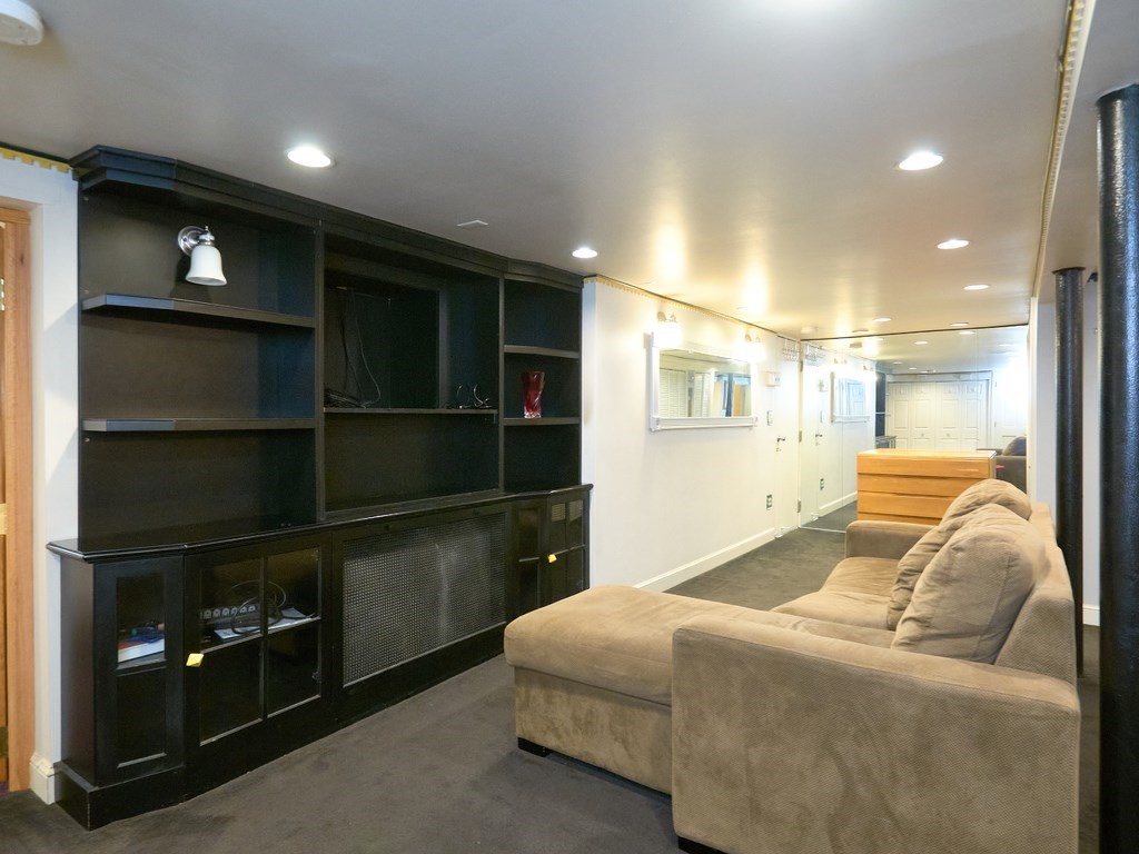 18 Atherton Road, Unit G Brookline, MA 02446 - Photo 7 of 15 a living room with a bed furniture and a window
