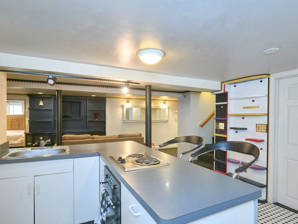 18 Atherton Road, Unit G Brookline, MA 02446 - Photo 8 of 15 a kitchen with stainless steel appliances a stove a sink and a refrigerator