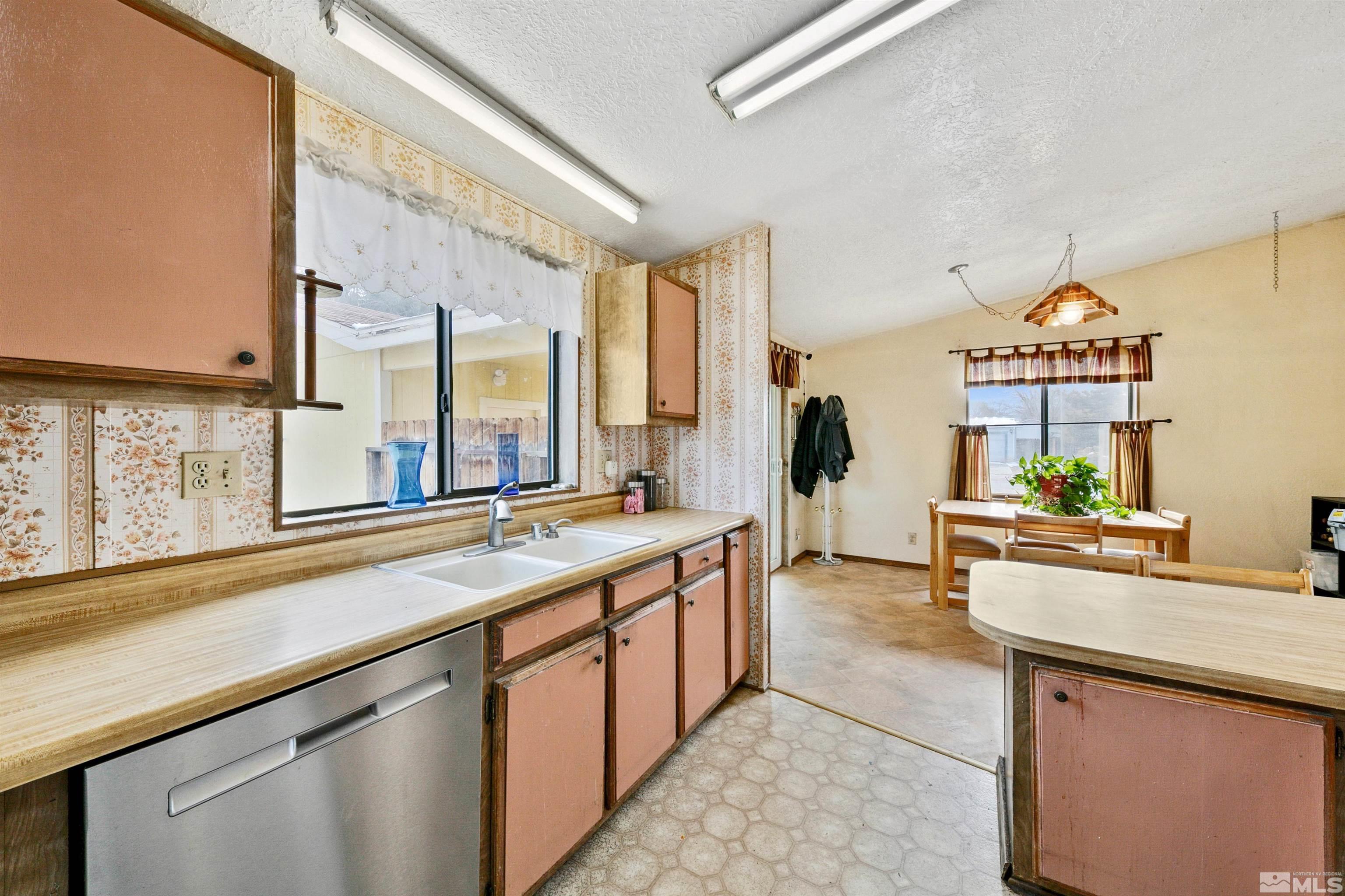 17405 Sunbird Lane Reno, NV 89508 - Photo 11 of 18 a large kitchen with stainless steel appliances a sink and cabinets