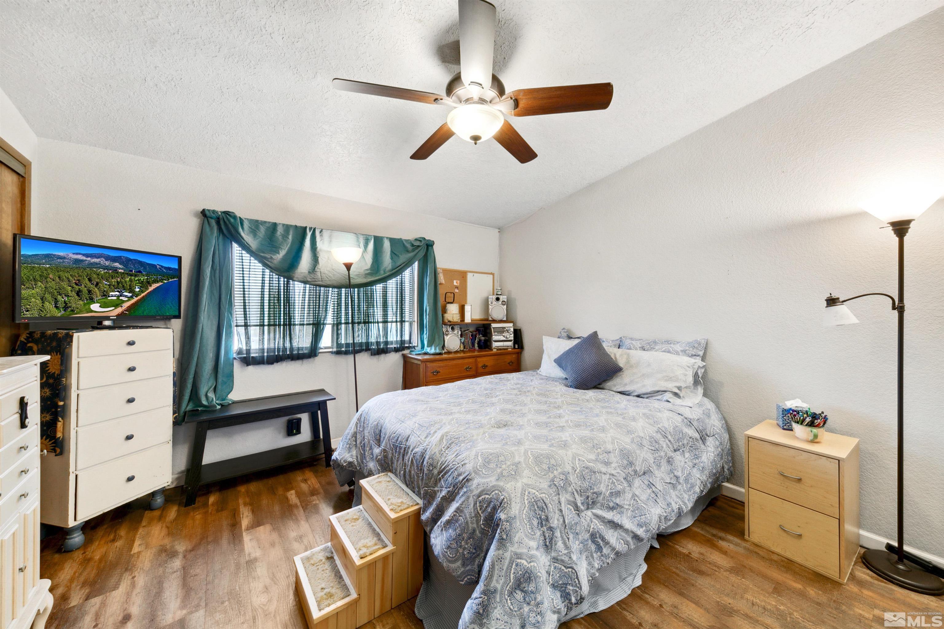 17405 Sunbird Lane Reno, NV 89508 - Photo 14 of 18 a bedroom with a bed and wooden floor