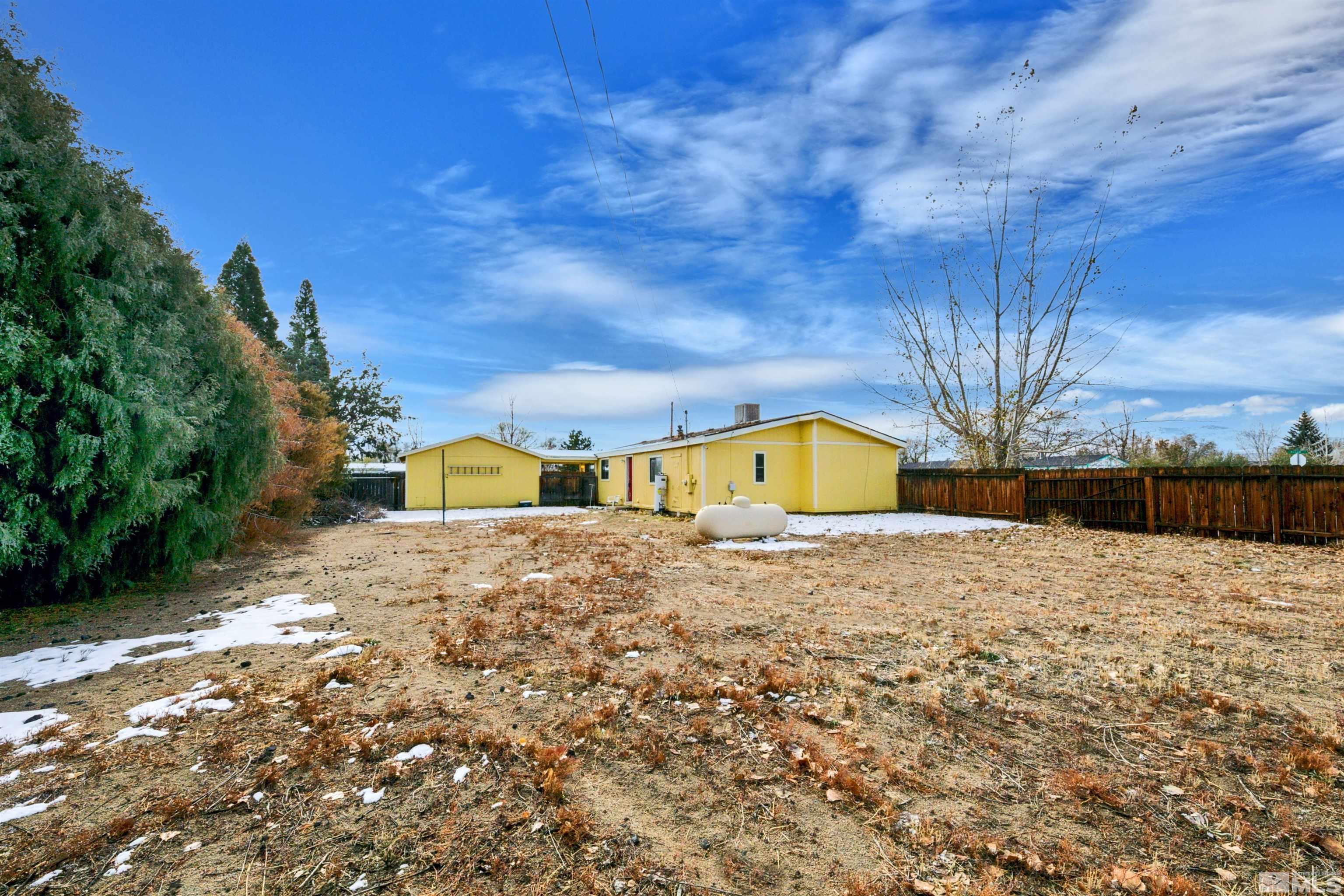 17405 Sunbird Lane Reno, NV 89508 - Photo 4 of 18 a yellow house with trees in front of it