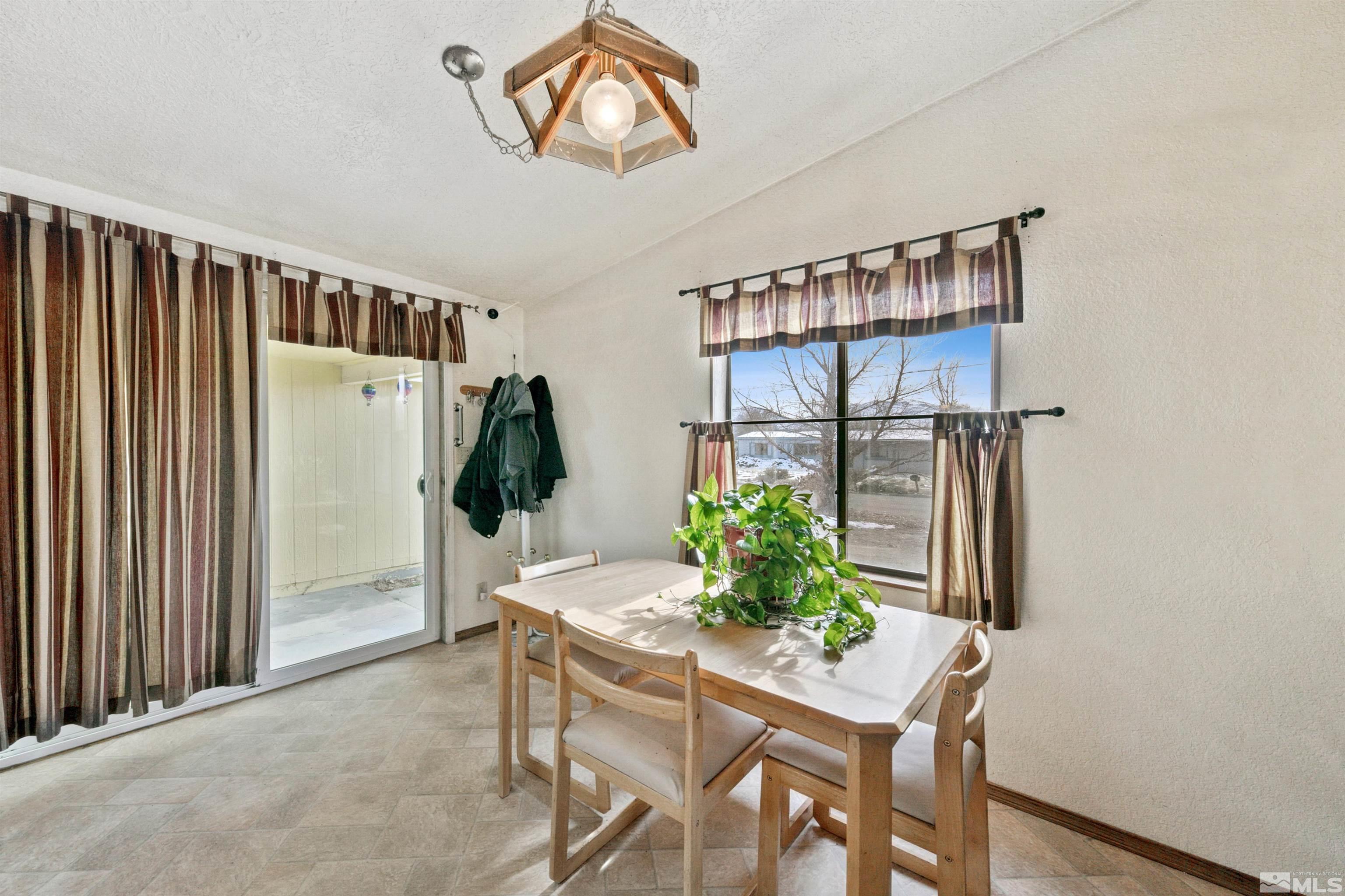 17405 Sunbird Lane Reno, NV 89508 - Photo 8 of 18 a dining room with furniture and a window