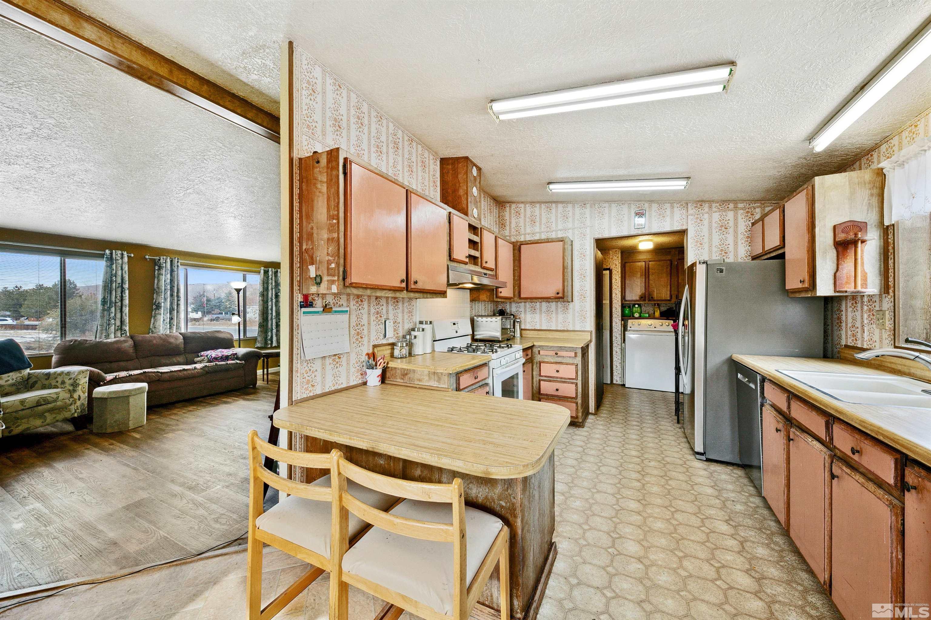 17405 Sunbird Lane Reno, NV 89508 - Photo 9 of 18 a kitchen with a table chairs refrigerator and couch