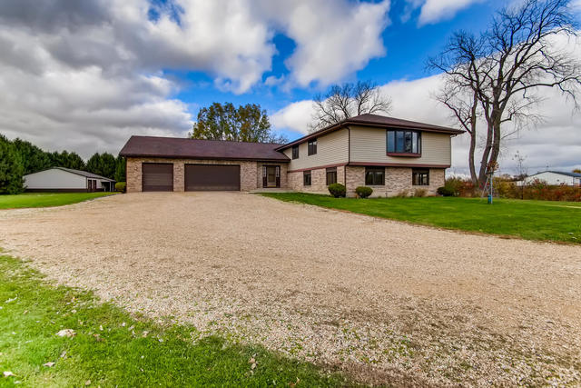 2N706 Howard Road Maple Park, IL 60151 - Photo 1 of 40 a front view of a house with a yard and potted plants