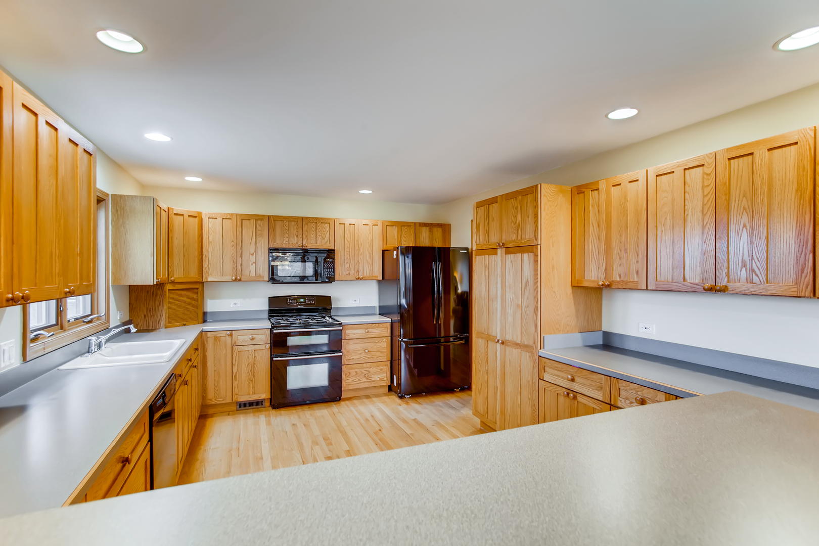 2N706 Howard Road Maple Park, IL 60151 - Photo 11 of 40 a large kitchen with stainless steel appliances wooden floor and a window