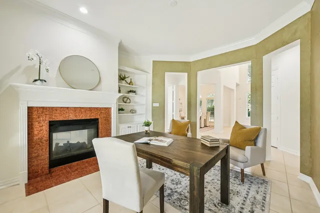 a living room with furniture a table and a fireplace