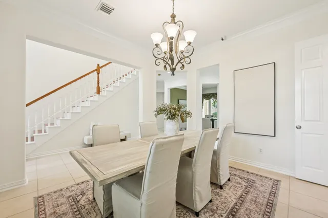 a view of a dining room with furniture and a chandelier