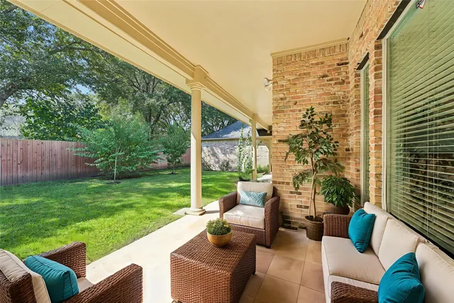 a view of a patio with couches chairs and a yard