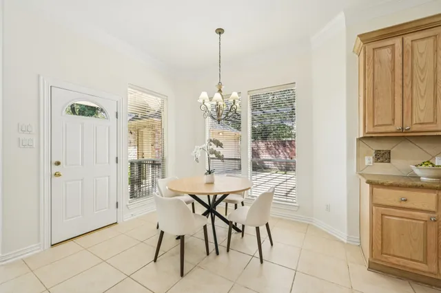 a view of a dining room with furniture and chandelier