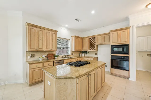 a kitchen with stainless steel appliances granite countertop a sink stove and cabinets