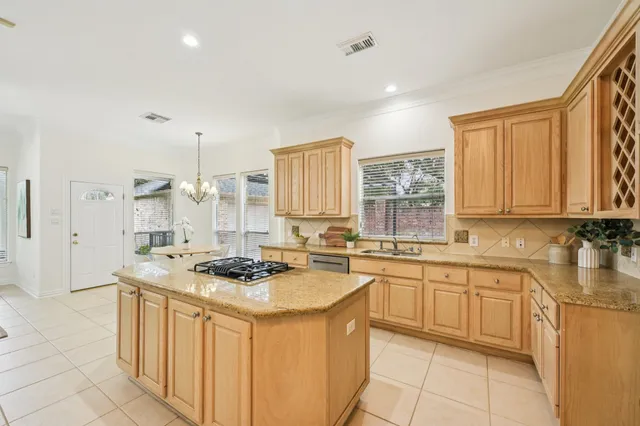 a kitchen with stainless steel appliances granite countertop a sink stove and cabinets