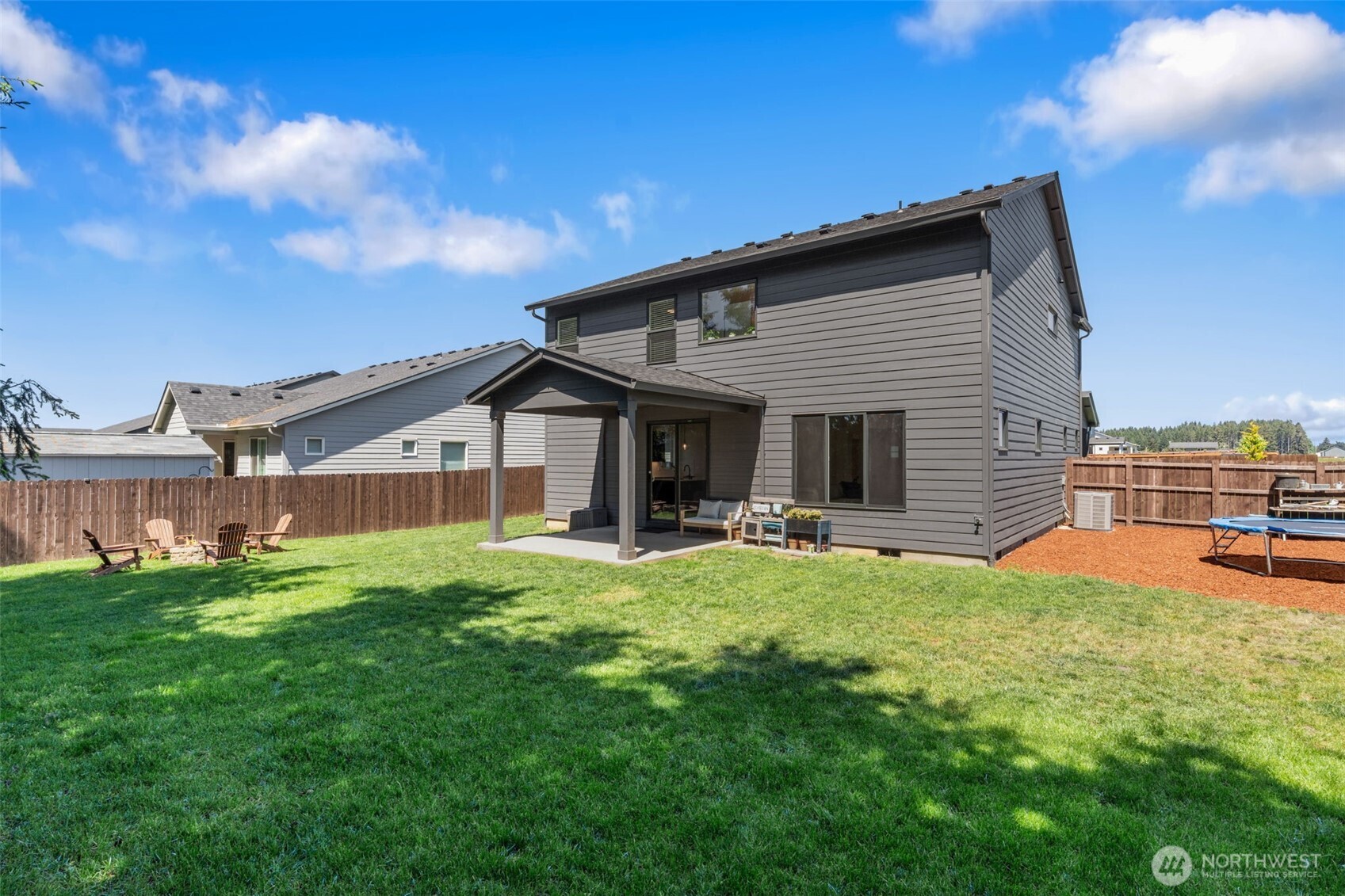 1090 Rw Fletcher Street Winlock, WA 98596 - Photo 34 of 40 a view of a house with a yard and sitting area