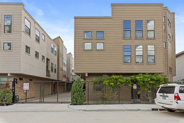 a car parked in front of a white building