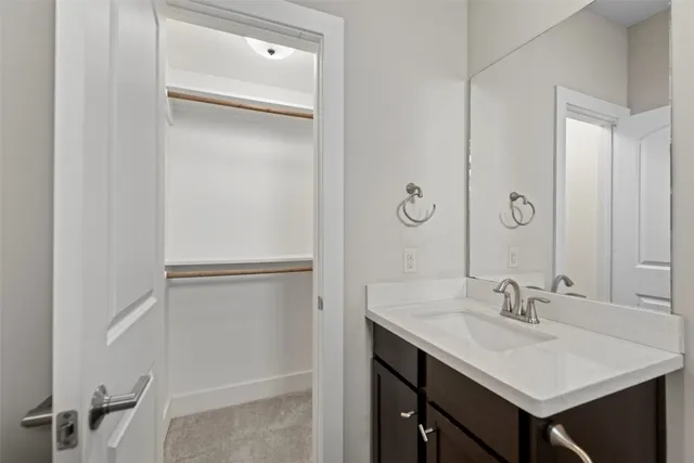 a bathroom with a sink mirror and shower