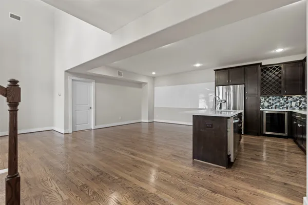 a view of kitchen with a sink and a refrigerator