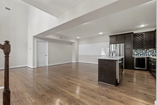 a view of kitchen with a sink and a refrigerator