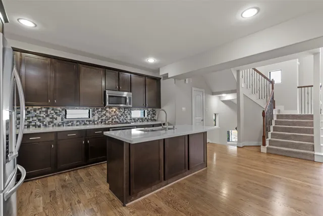 a kitchen with stainless steel appliances granite countertop a sink and cabinets