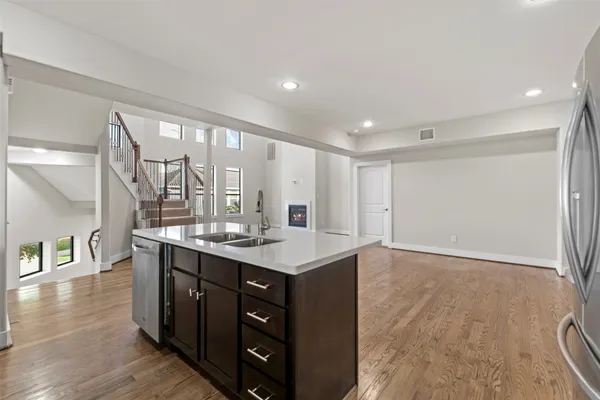 a kitchen with a sink cabinets and wooden floor
