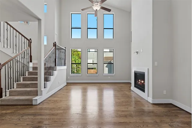 a view of an entryway with wooden floor and a fireplace