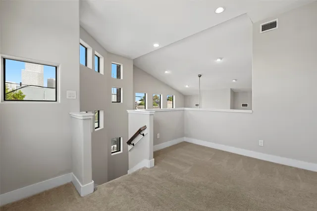 an empty room with windows and closet