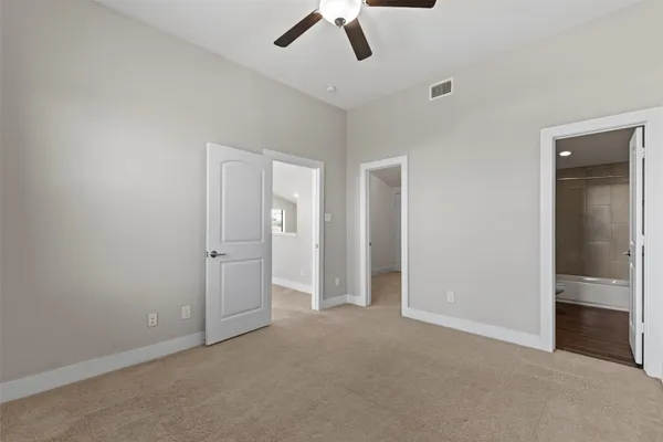 a bathroom with a sink toilet vanity and shower