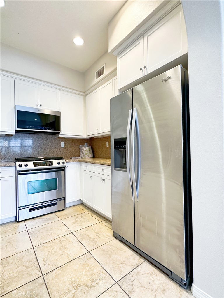 30 Pink Sage Irvine, CA 92620 - Photo 2 of 11 a kitchen with stainless steel appliances a refrigerator sink and microwave