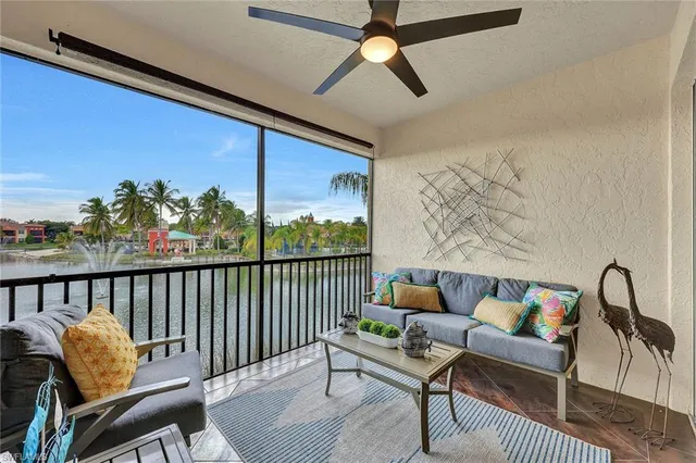 an aerial view of residential houses with outdoor space and lake view