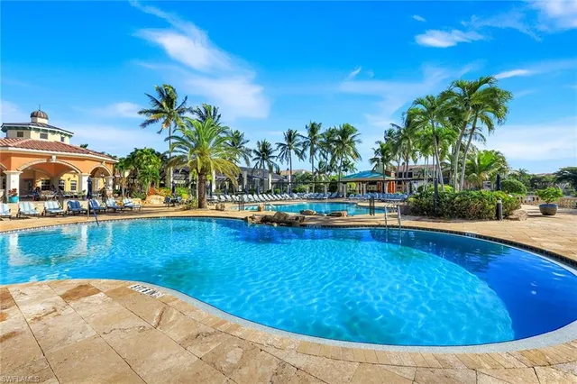 a view of swimming pool with outdoor seating and lake