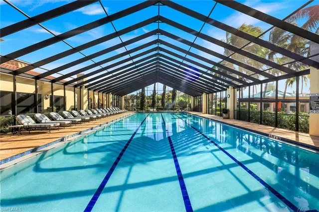 an aerial view of residential houses with outdoor space and lake view