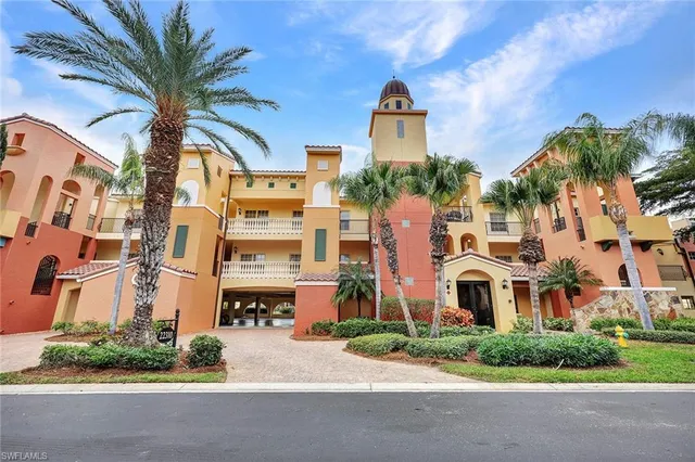a living room with furniture a rug kitchen view and a large window