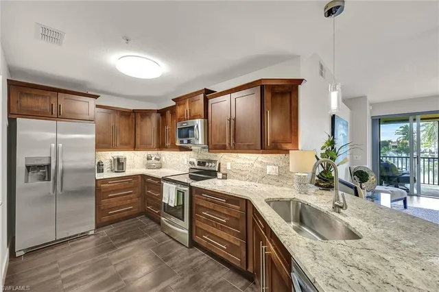 a kitchen with a sink stove top oven and cabinets