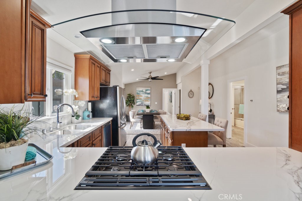 a large kitchen with stainless steel appliances granite countertop a stove and cabinets