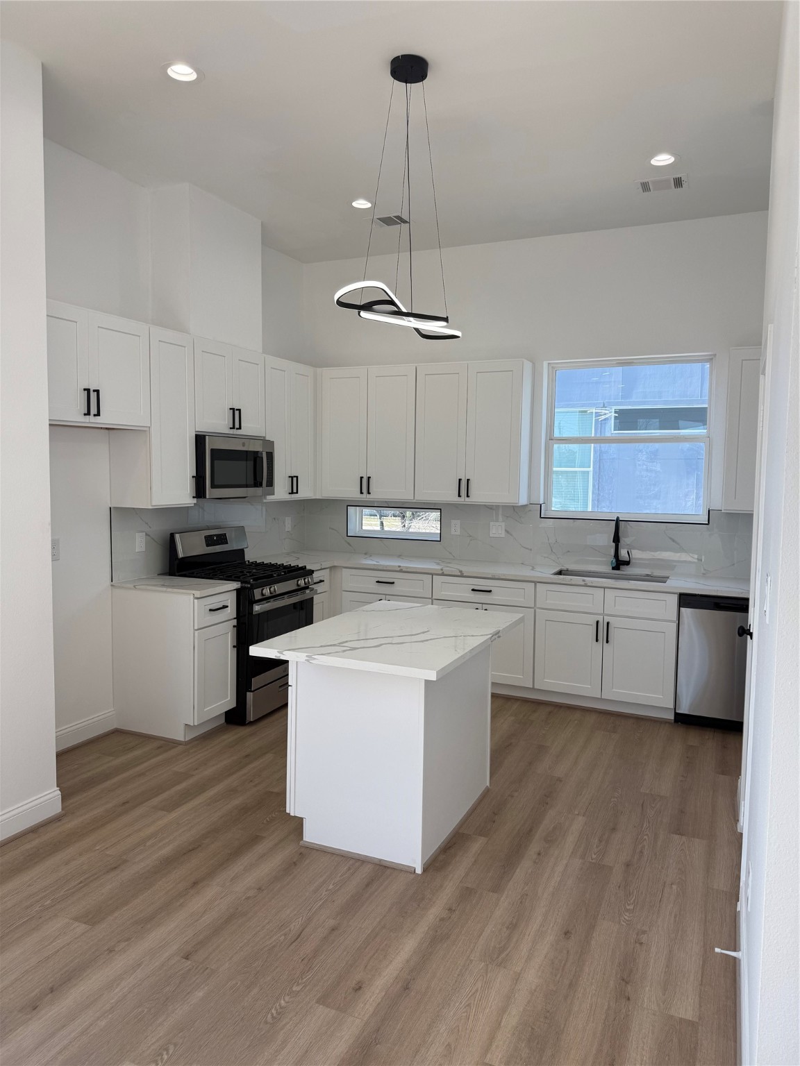 6350 Culberson Street Houston, TX 77021 - Photo 17 of 34 a kitchen with kitchen island granite countertop a sink cabinets and stainless steel appliances