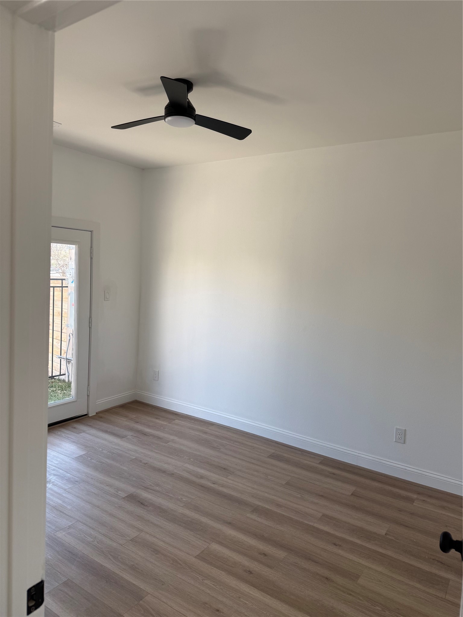 6350 Culberson Street Houston, TX 77021 - Photo 6 of 37 a view of an empty room with wooden floor and a window