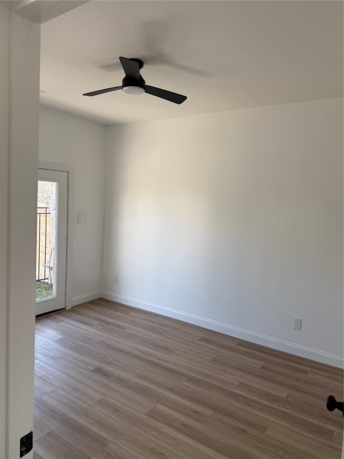 6350 Culberson Street Houston, TX 77021 - Photo 6 of 34 a view of an empty room with wooden floor and a window