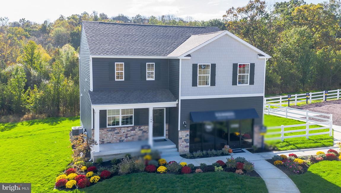 a front view of a house with a yard table and chairs